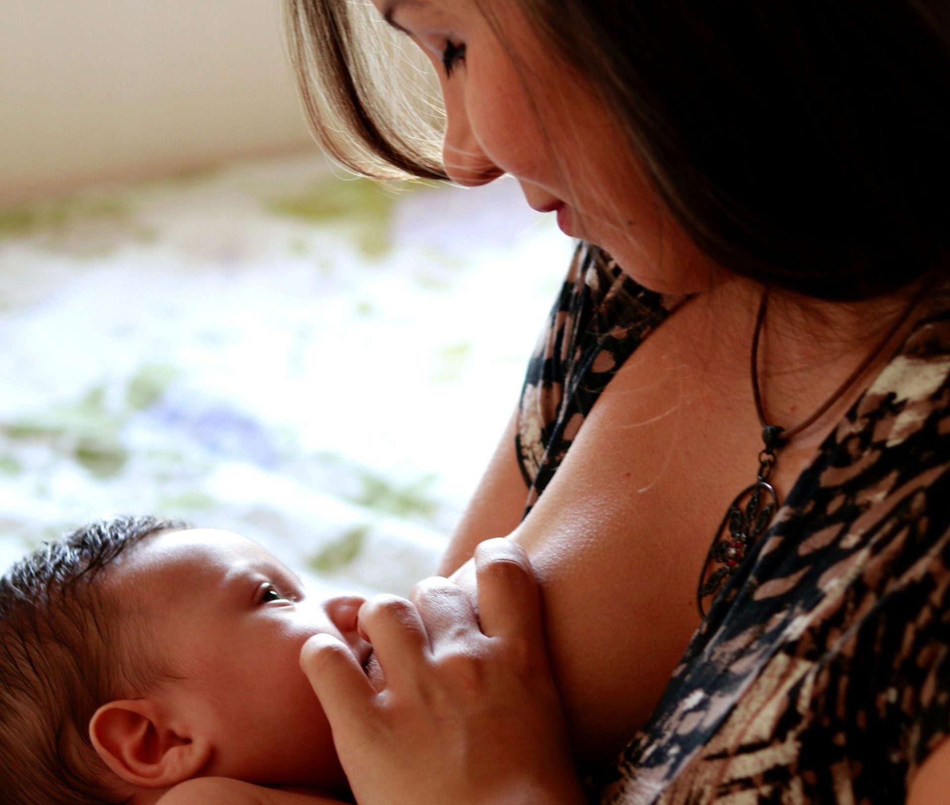 A woman breast feeding her baby