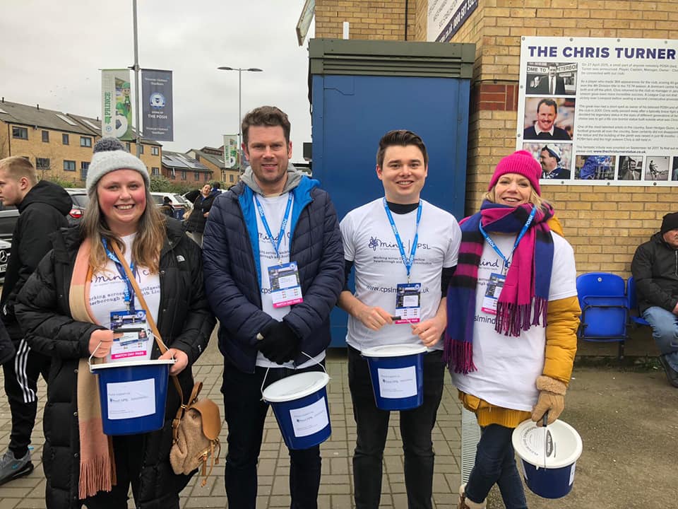 A group of people wearing CPSL Mind t shirts holding collection buckets