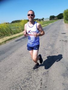 Man in running gear running down the road