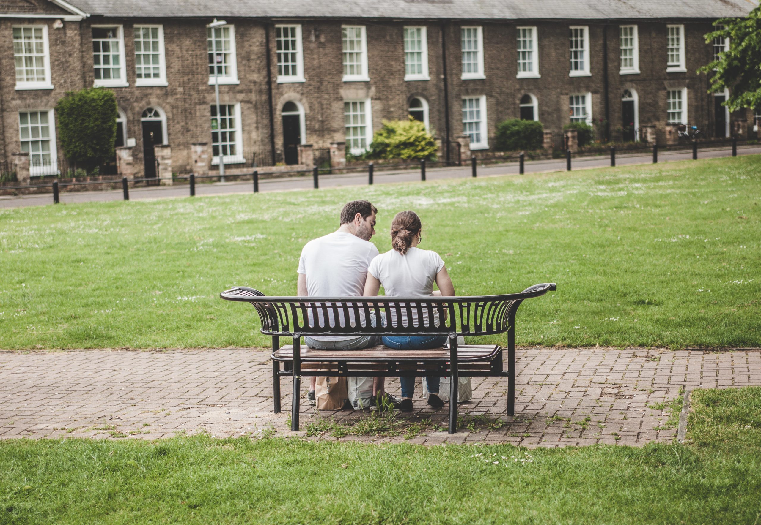 Mental Health First Aid training - people sat on bench outside buildings