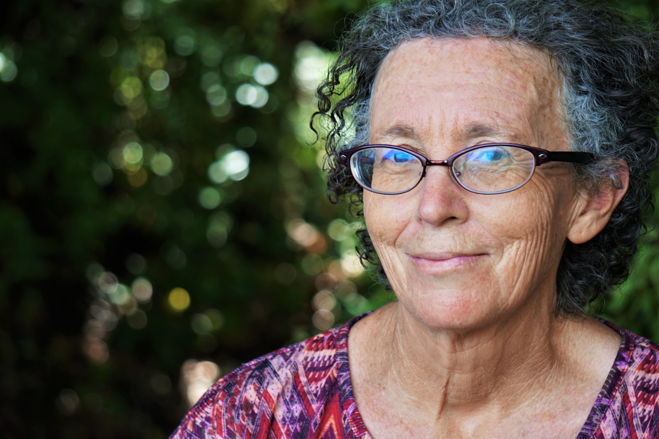 Senior woman with glasses smiling at the camera