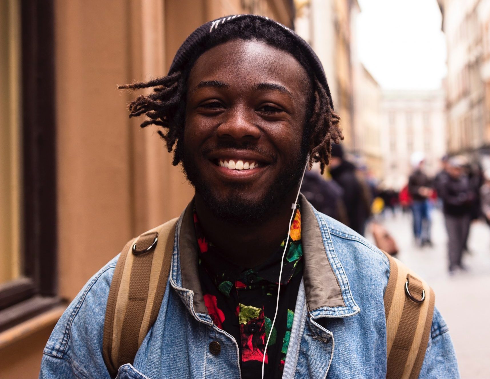 Black man smiling standing on the street