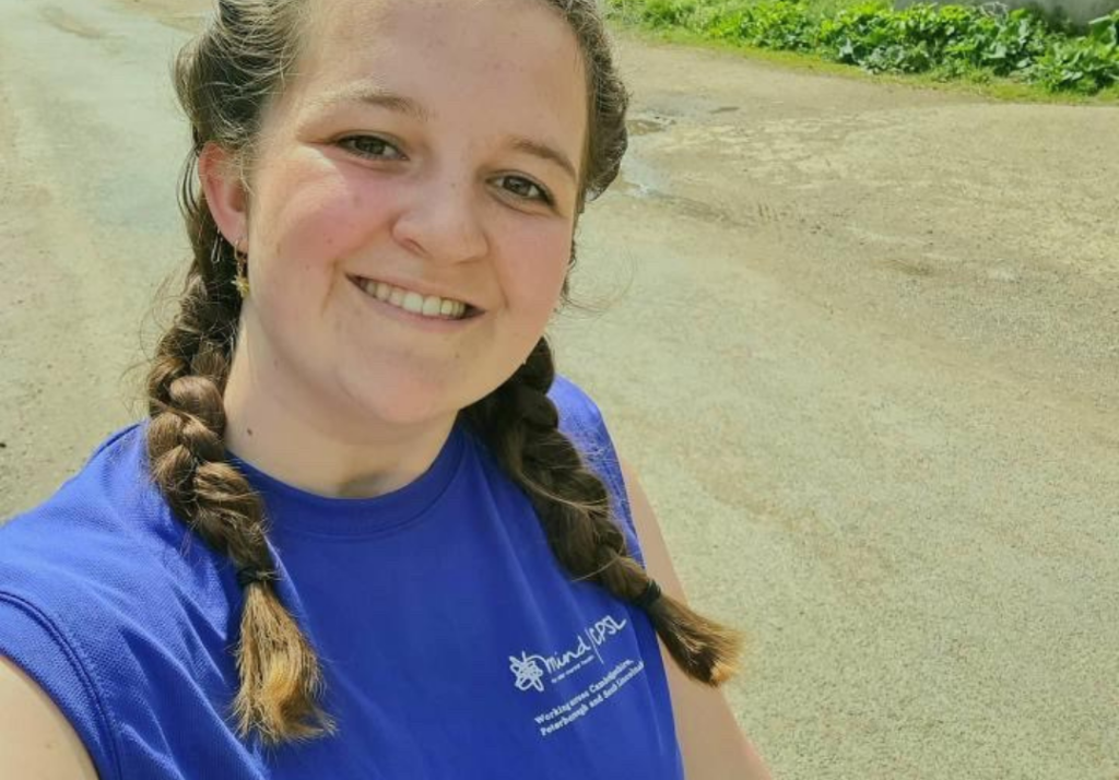 Girl with plaited pigtails taking a selfie in a blue CPSL Mind tshirt