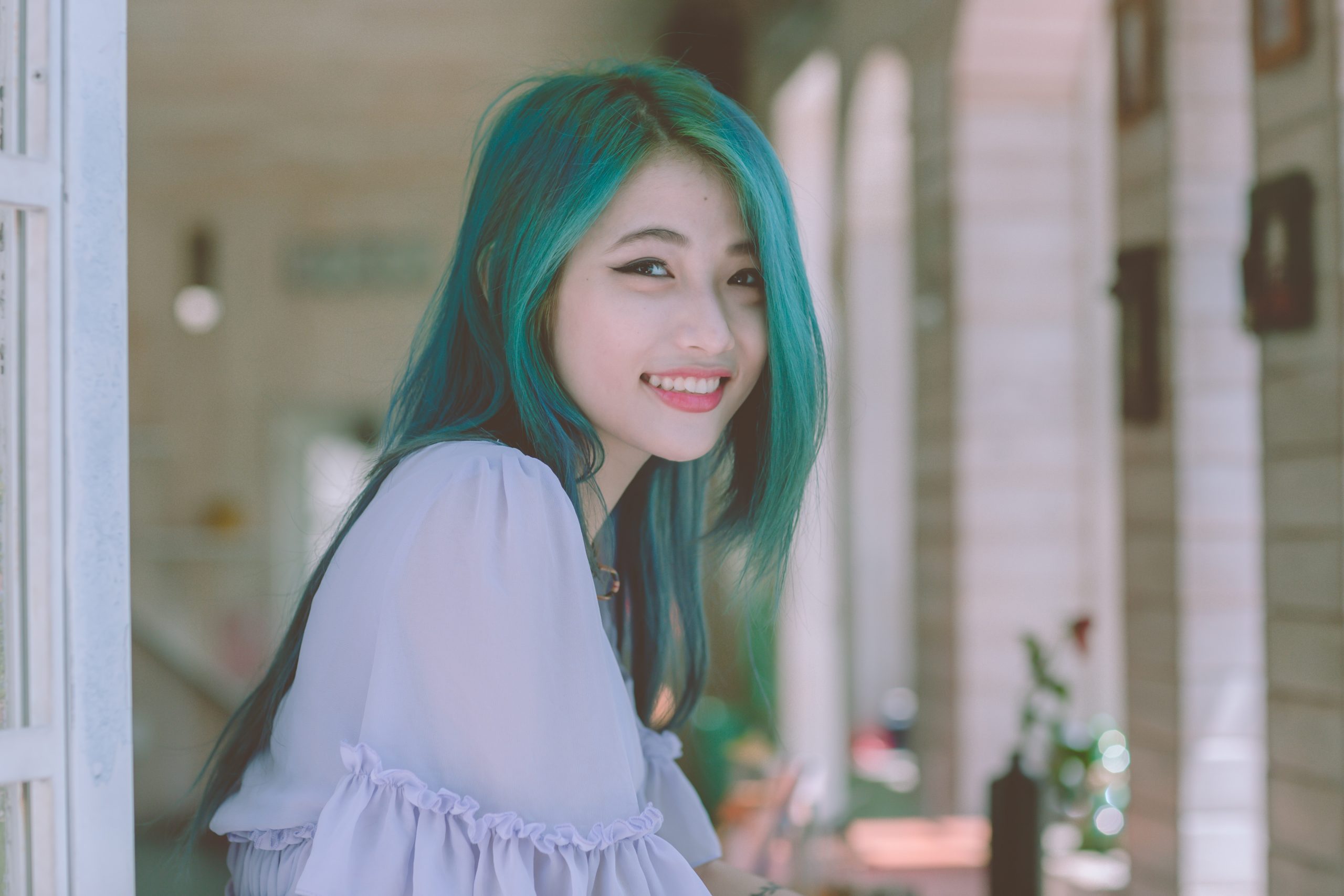 Girl with blue hair smiling