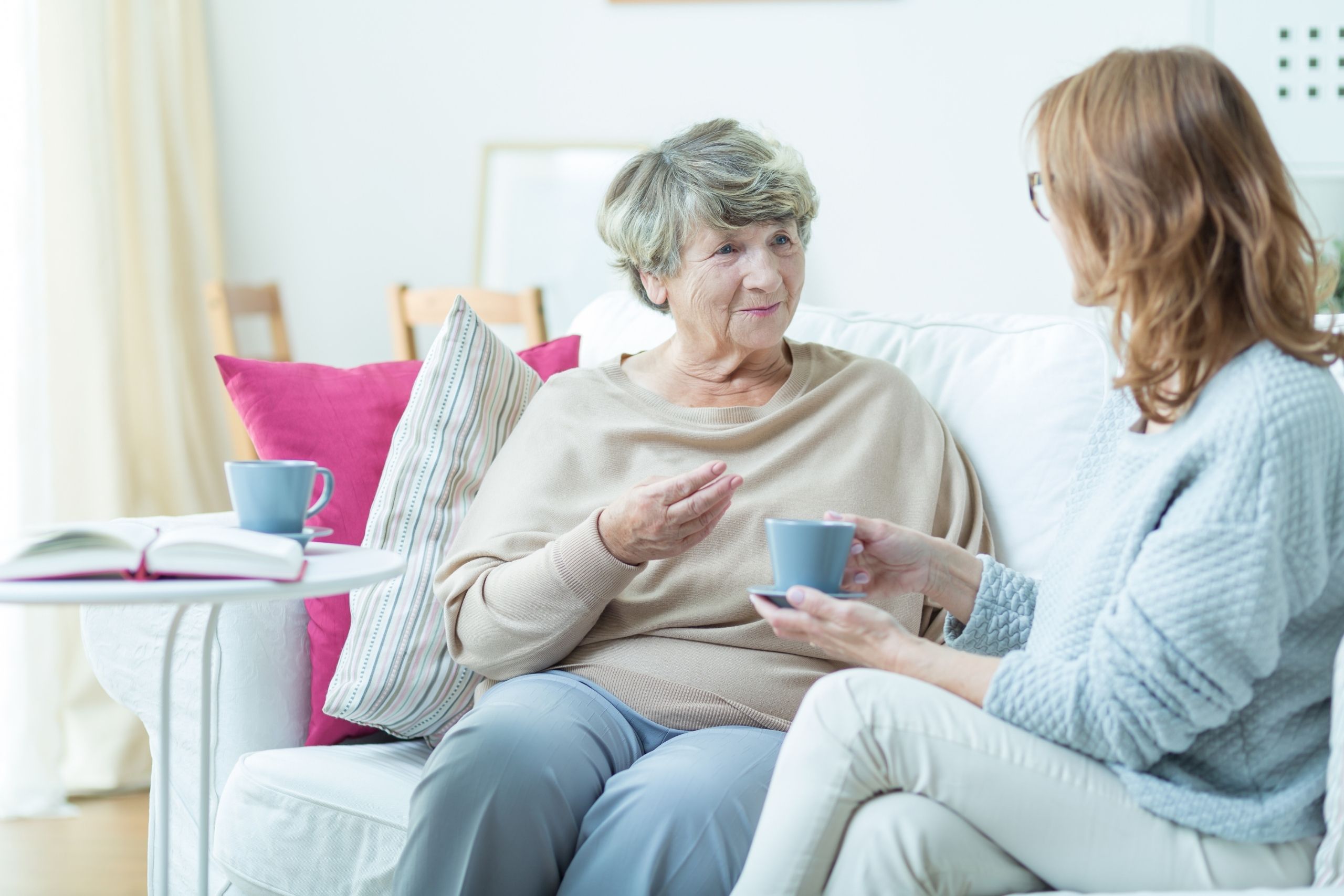 Two women talking on a sofa - mental health crisis support