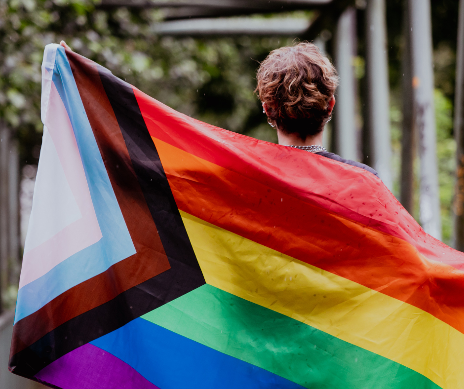 A person holding the pride flag